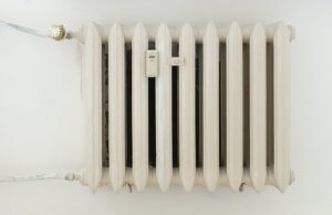 white steel rib radiator in a new bright renovated room in apartment or home