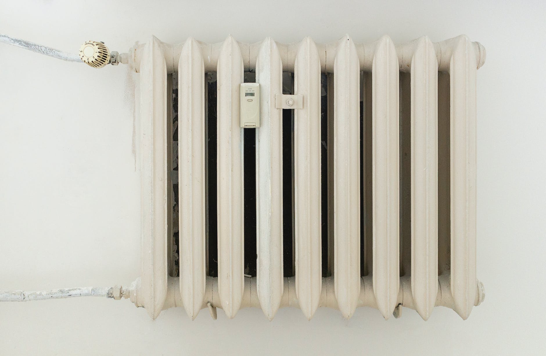 white steel rib radiator in a new bright renovated room in apartment or home Benefits of Heating Oil Additives